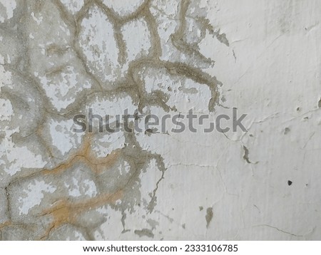 Partially cracked stuco surface stock photo.