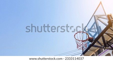 Basketball hoop and backboard with blue sky copy space