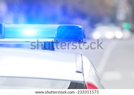 Police car with lights turned on. Royalty-Free Stock Photo #233311573