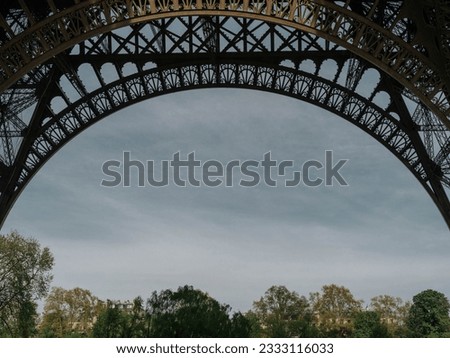Stunning view through the bottom arch of the Eiffel Tower,