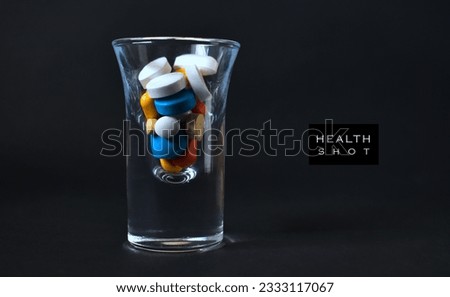 Health shot concept with medicinal pills placed in shot glass. 