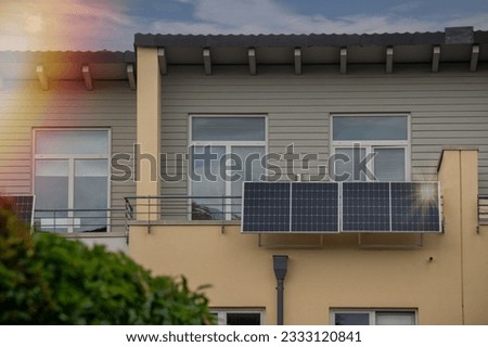 Solar power plant on a balcony with sunlight reflection and special lens flare light effect. Balcony solar power station eco-friendly to use renewable energy. 