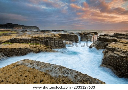 Sunrise skies from the eroded rocky channel at North Narrabeen near Sydney, Australia