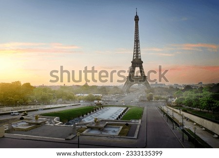 Eiffel Tower and fountains near it at dawn in Paris, France