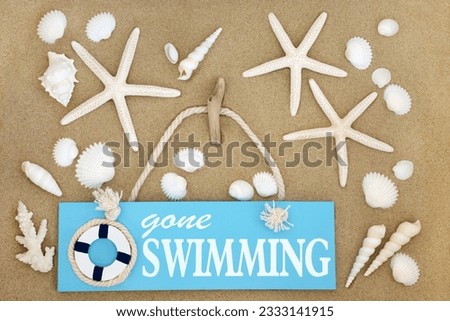 Gone swimming sign on sand with starfish and seashells forming an abstract background.
