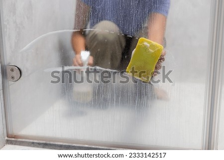 Removing hard water stains and deposits in bathroom Royalty-Free Stock Photo #2333142517
