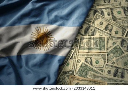 big colorful waving national flag of argentina on a american dollar money background. finance concept
