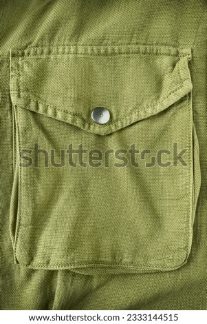 Khaki military jacket flap pocket closeup as a background