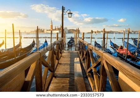 Condolas and wooden pier in Venice, Italy