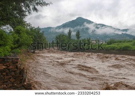 Heavy Flood after Heavy Rain In the Local Stream. Flood Water Entered very Fast to the Houses and Shops . Houses to Near The Ban are Destroyed Badly. Swat Valley. Dated 24th August 2022. Royalty-Free Stock Photo #2333204253
