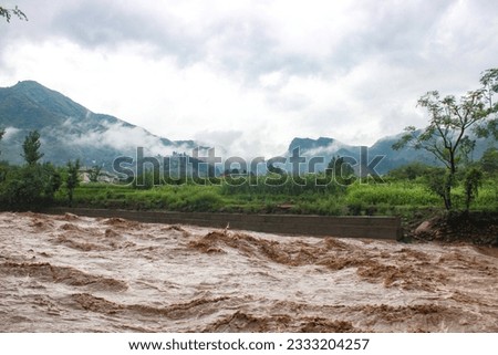 Heavy Flood after Heavy Rain In the Local Stream. Flood Water Entered very Fast to the Houses and Shops . Houses to Near The Ban are Destroyed Badly. Swat Valley. Dated 24th August 2022. Royalty-Free Stock Photo #2333204257