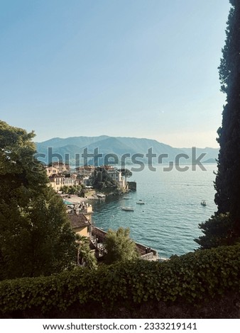 Varenna, Italy June 2023- View of Varenna and Lake Como from above. Mountains, trees, water, and buildings pictured. 