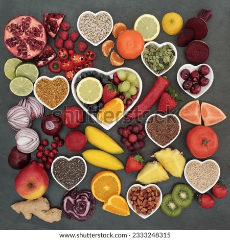 Paleolithic diet health and superfood of fruit, vegetables, nuts and seeds in heart shaped bowls on slate background, high in vitamins, antioxidants, anthocyanins, dietary fiber and minerals. Royalty-Free Stock Photo #2333248315