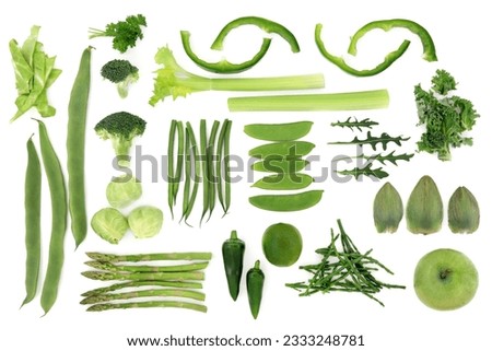 Green fresh vegetable and fruit selection over white background, high in antioxidants and vitamins.