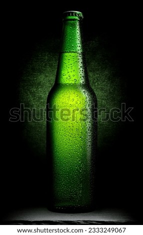 Bottle of green beer on a black background