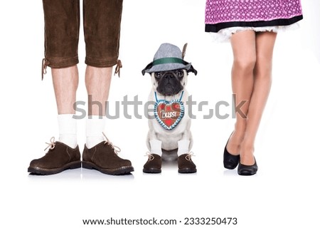 pug dog with gingerbread heart and bavarian couple of family owners , isolated on white background