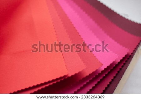 Samples of satin fabric in red and crimson colors