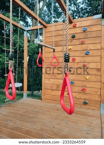 Sports ground for gymnastics and exercises for children. Rope trainer place of climbing wall in park. Leisure.
