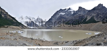 Panoramic photography of a snowy mountain range and a lagoon