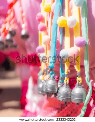 Loei, Thailand - June, 25, 2023 : Ghost Festival (Phi Ta Khon) people dress up and wear colorful handmade wooden masks sing and dance joyfully.