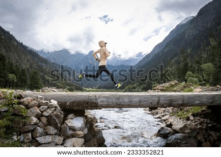 Woman trail runner cross country running in high altitude mountains Royalty-Free Stock Photo #2333352821