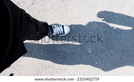 Sneakers with male legs, tourist top view shot, travel tourism concept Royalty-Free Stock Photo #2333402759