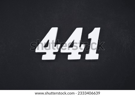 Black for the background. The number 441 is made of white painted wood. Royalty-Free Stock Photo #2333406639