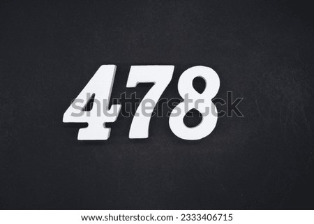 Black for the background. The number 478 is made of white painted wood. Royalty-Free Stock Photo #2333406715