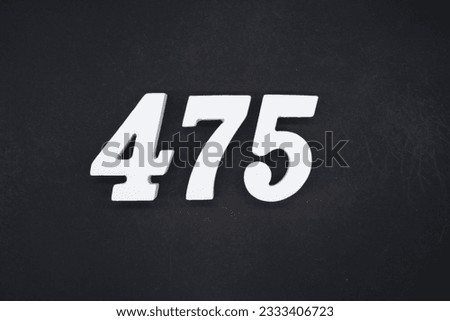 Black for the background. The number 475 is made of white painted wood. Royalty-Free Stock Photo #2333406723