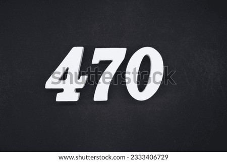 Black for the background. The number 470 is made of white painted wood.