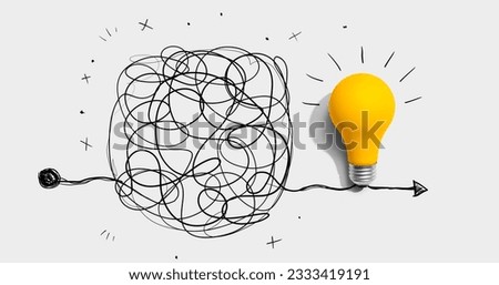 Clarifying complex ideas theme with light bulb - Flat lay Royalty-Free Stock Photo #2333419191