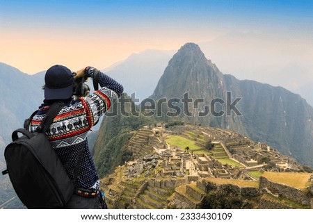  tourist and photographer taking photo at Machu Picchu, one of seven wonders and famous tourist attraction in Cusco Region of Peru. This majestic place has known as Lost City of the Incas. Royalty-Free Stock Photo #2333430109
