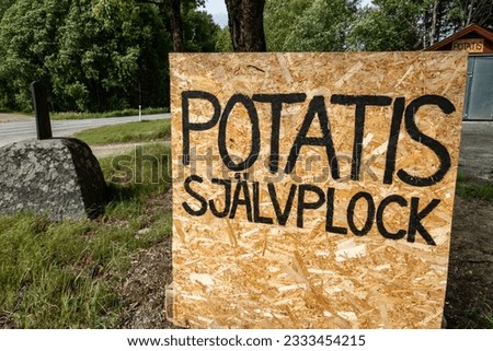 Falun, Sweden A ´sign onthe side of the raod advertsies in Swedish translation Potatoes self pick.