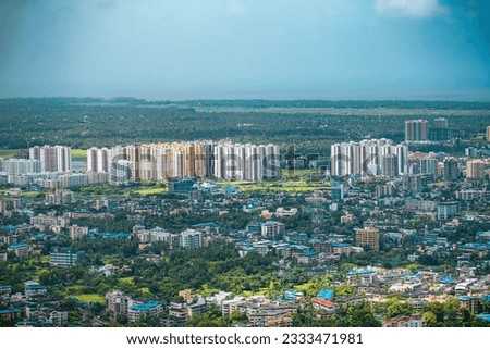 Aerial view of residential houses and high-rise buildings in Virar city of Palghar District in Maharashtra, Top angle Drone shot, houses in a smart city, living in India. Beautiful Indian city.