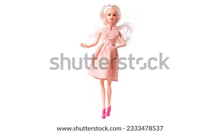 Plastic doll in dress isolated on white background. High quality photo Royalty-Free Stock Photo #2333478537