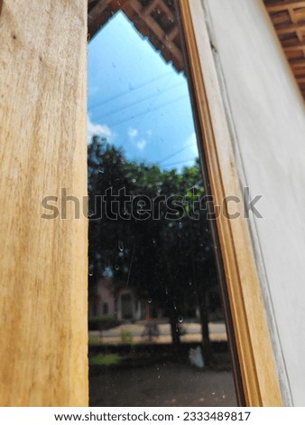Wooden window frame with black-colored glass.