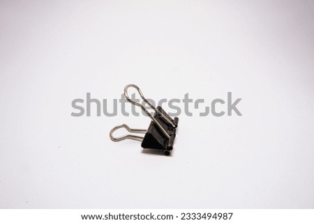 Black Paper Clips on White Background. Isolate, Free Space, Close-up.