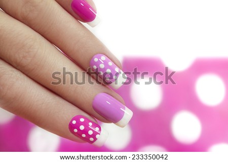 	  Nail design with white dots on the French manicure with pink varnish of various shades. Royalty-Free Stock Photo #233350042