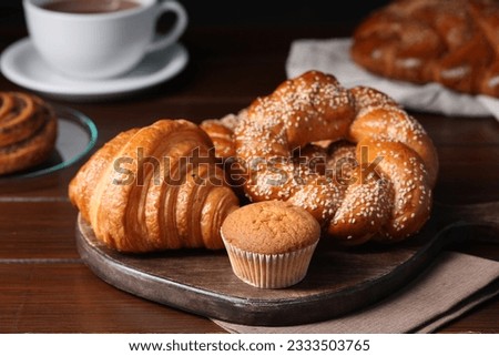 Different tasty freshly baked pastries on wooden table, closeup Royalty-Free Stock Photo #2333503765