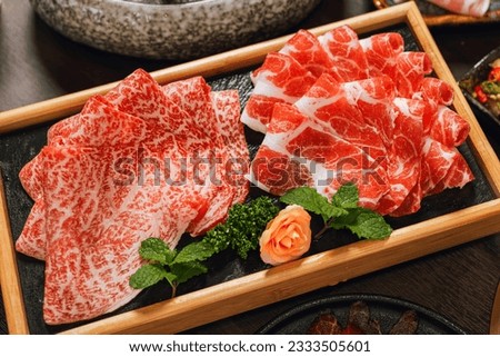 Premium Rare Slices pork with high-marbled texture on circle wooden plate served for hot pots and Shabu. Royalty-Free Stock Photo #2333505601