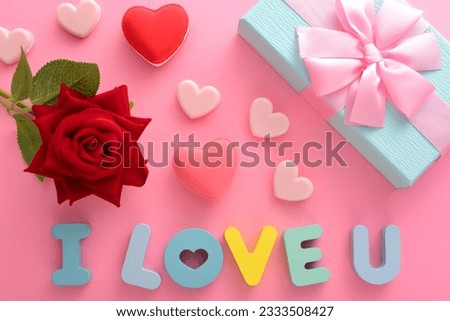 Rose Gift Box with Love and Letters on a Pink Background I Love You