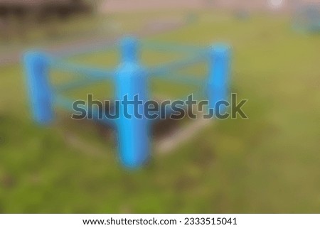 Blurred defocused photo of A blue-colored square hydrant enclosure with iron pipes, for background template. Out of focus, noise, over or under exposure, over compressed effect.