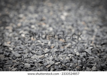 Wallpaper picture of gray granite pebbles floor with a blurred background for graphic design work