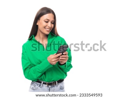 young brown-eyed brown-haired woman in a green blouse chatting on the phone Royalty-Free Stock Photo #2333549593