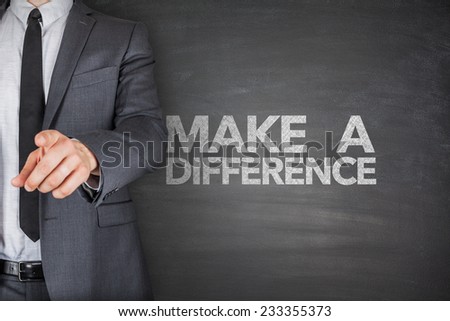 Make a difference on black blackboard with businessman