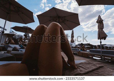 close up portrait legs of beautiful girl in bikini on the beach