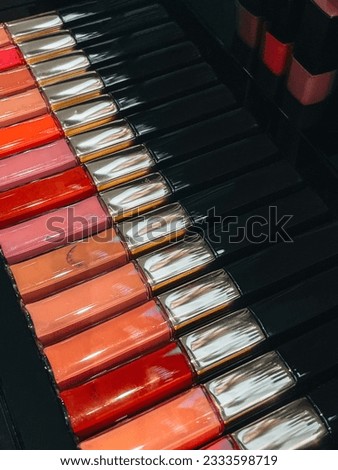 Chanel red pink orange glossy lip balm in a row. Makeup and female beauty product concept