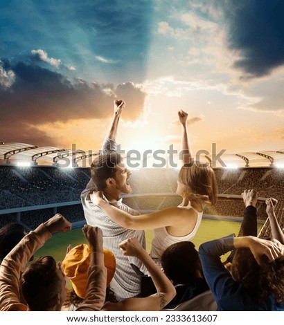 Victory, win. Football fans support their team, excited couple men and woman shouting, chanting name of team over evening sport arena. Concept of sport, emotions, competition and success. Royalty-Free Stock Photo #2333613607