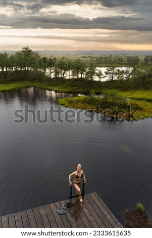 A young girl bathes in a forest lake in the Marimetsa swamp. High quality photo