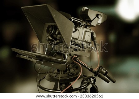 A video camera. Professional videographer at working